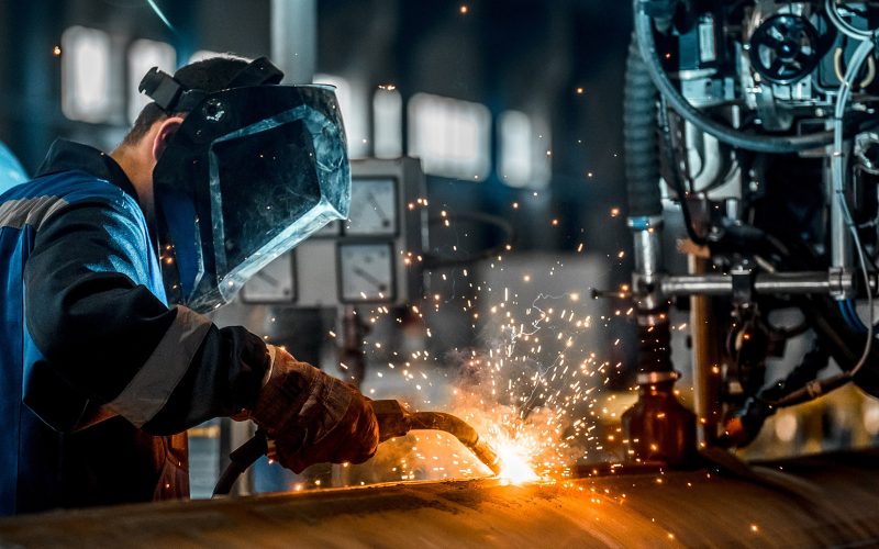man welds at the factory